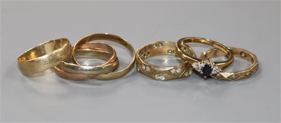 Five assorted 9ct gold rings including gem set and a Russian triple wedding ring.